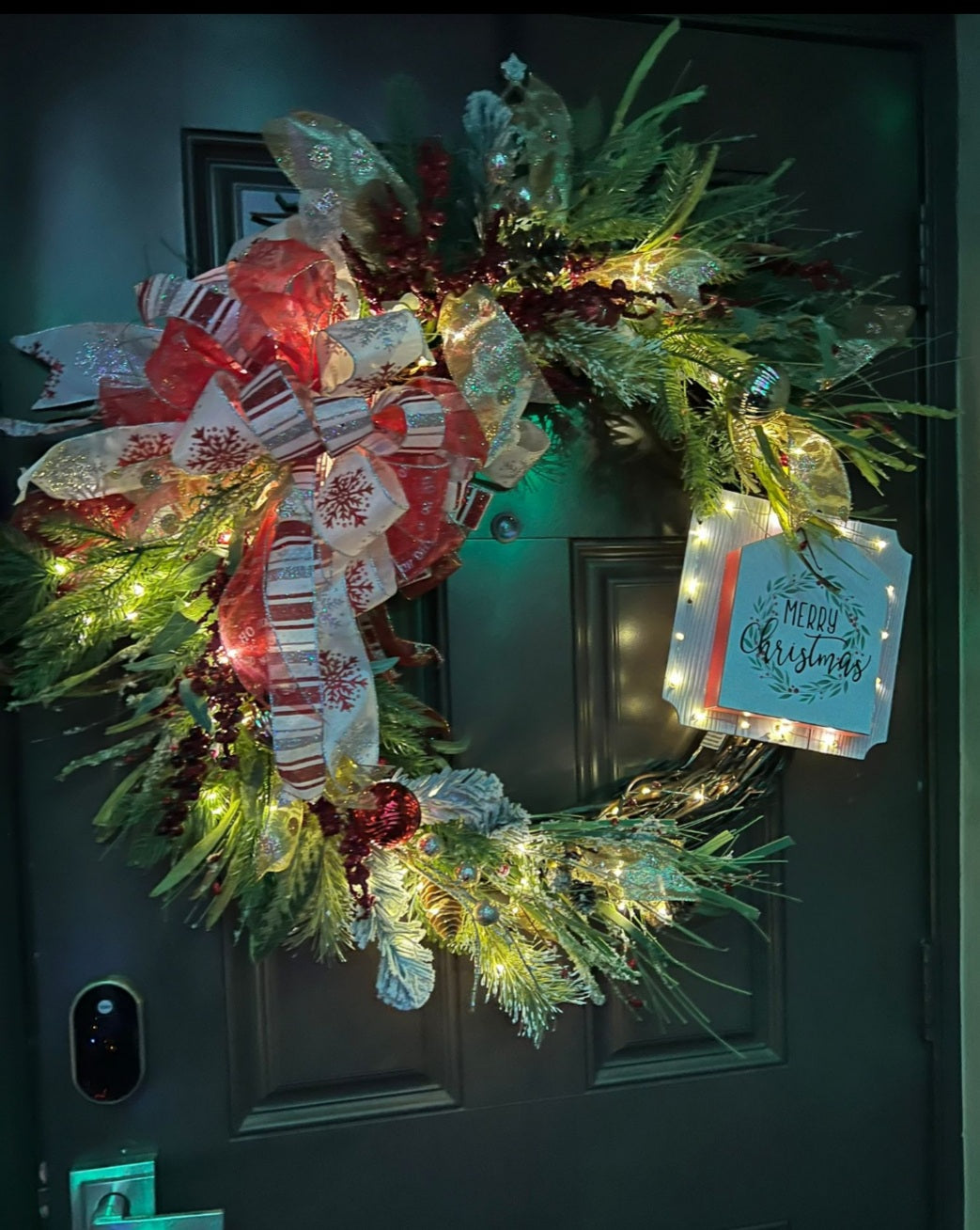 Christmas wreath with a message in a wood sign