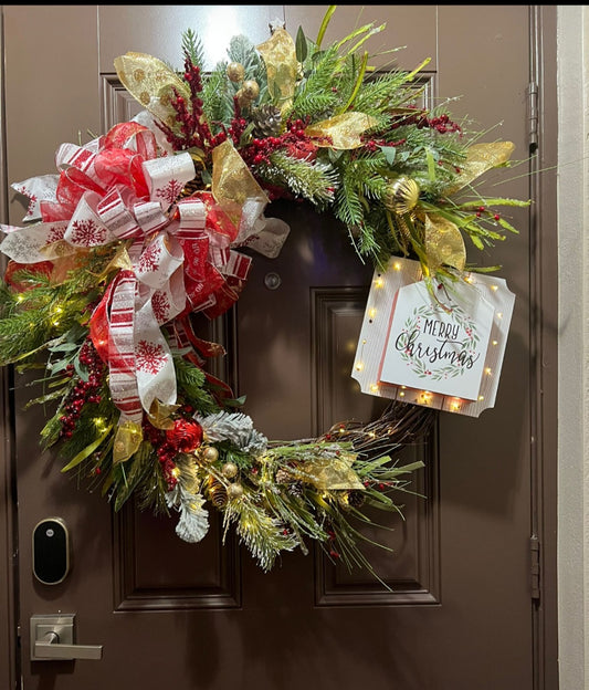 Christmas wreath with a message in a wood sign