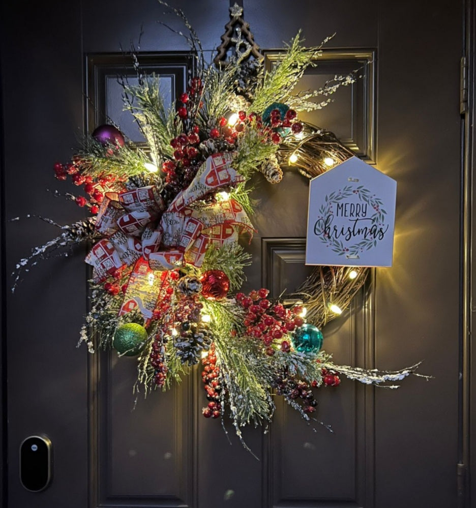 Christmas wreath with a message in a wood sign