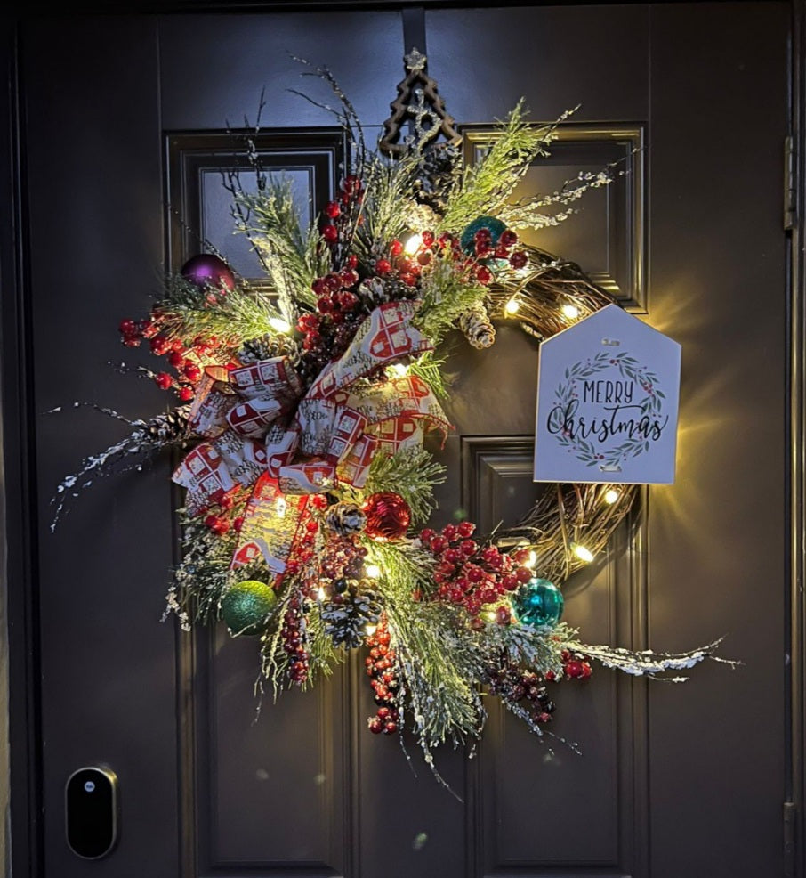 Christmas wreath with a message in a wood sign