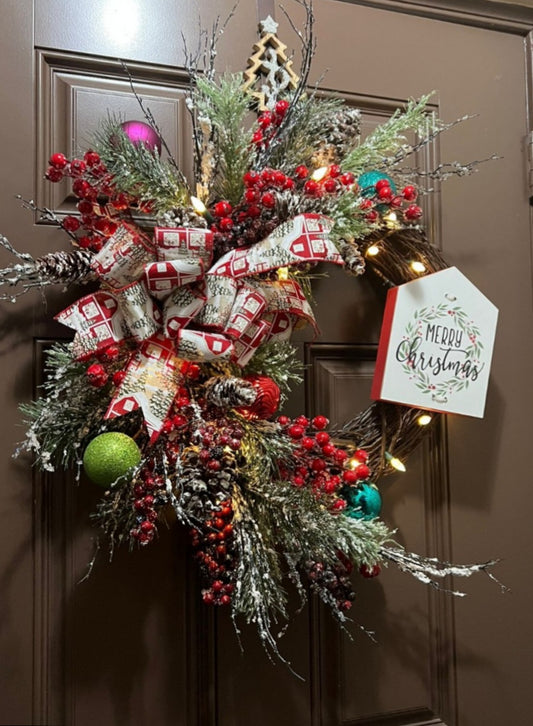 Christmas wreath with a message in a wood sign